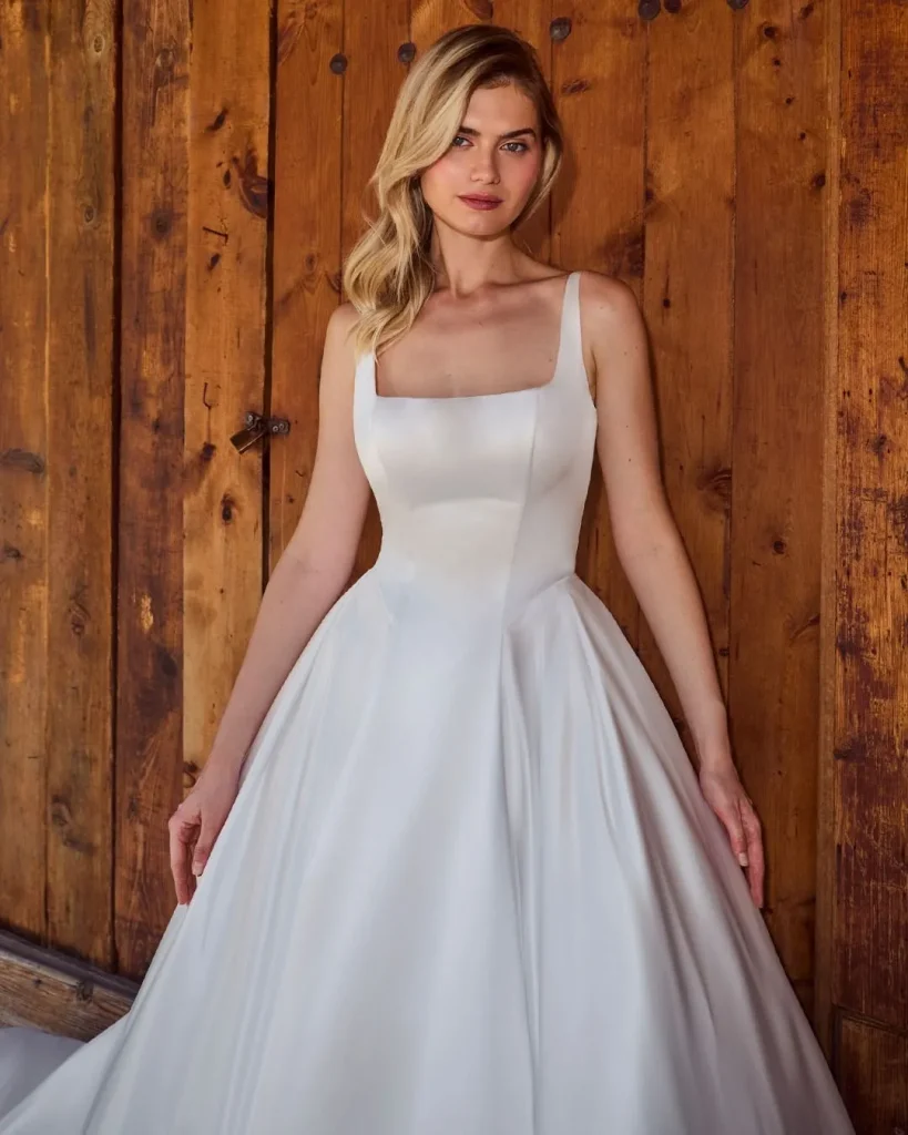 Bridesmaid wearing a dusty rose scoop neck dress for broad shoulders