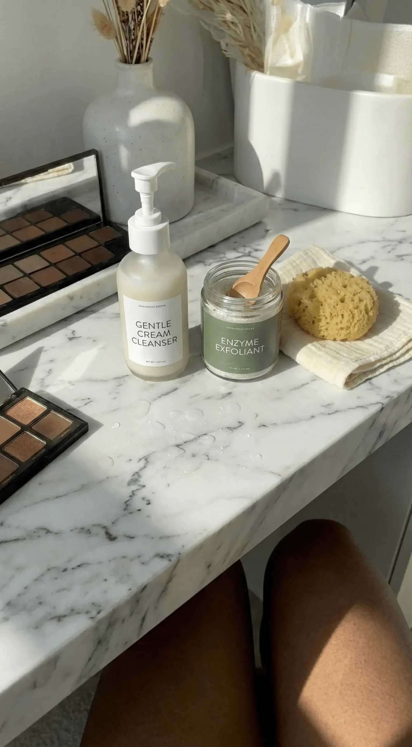 Skincare flat lay with milky cleanser and exfoliant for smooth skin prep