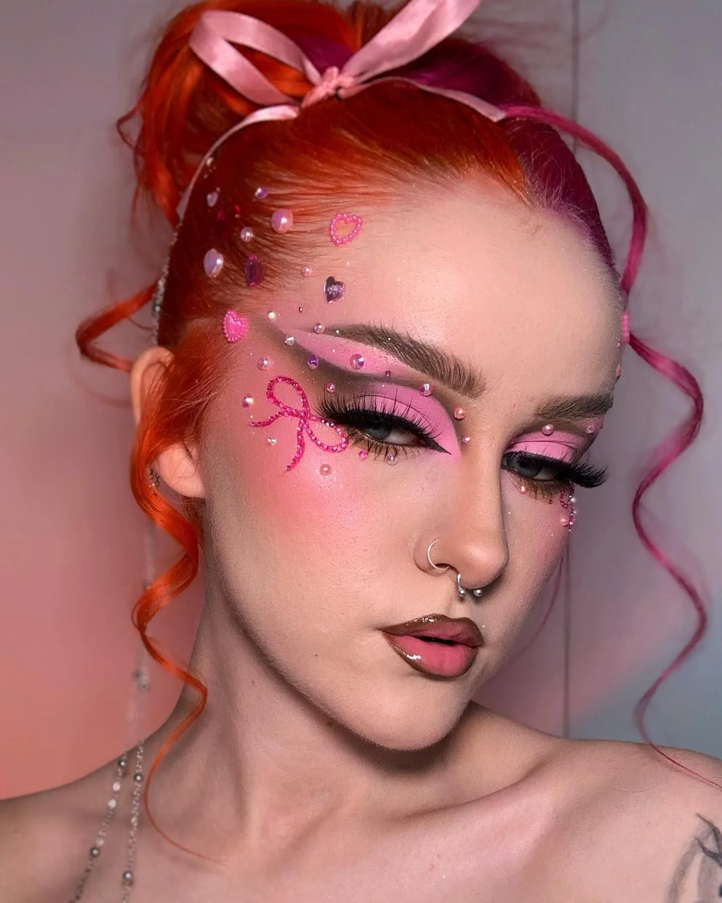 Model with glowing skin and flushed pink cheeks wearing a hair ribbon