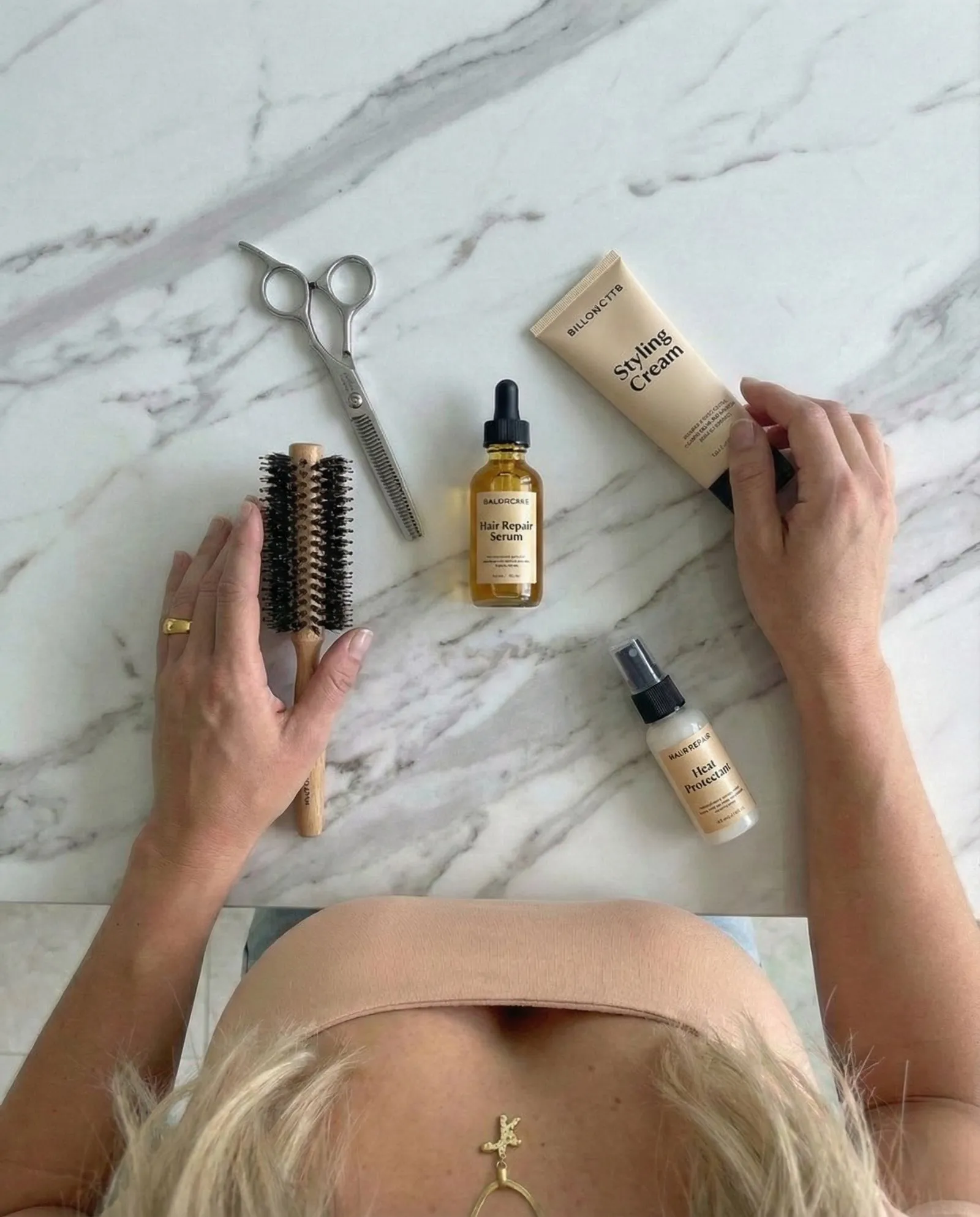 Flat lay of scissors and hair care products