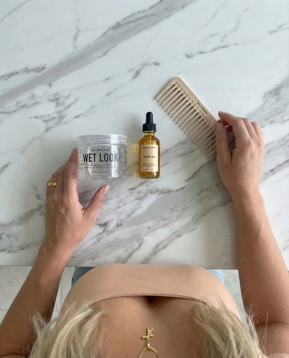 Flat lay of hair gel oil and comb for wet look styling