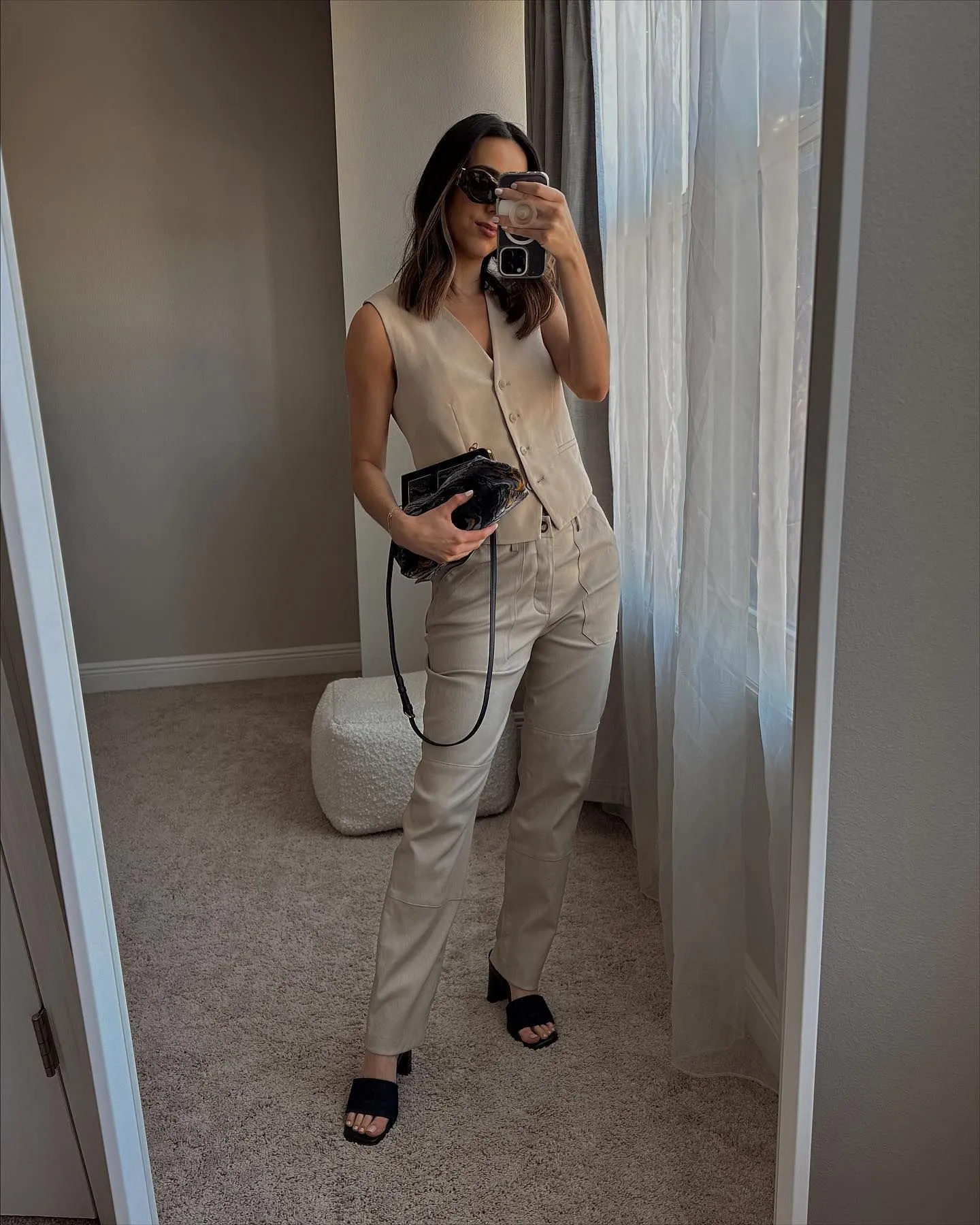 Two women of different body types styling tailored waistcoats for a professional office look.