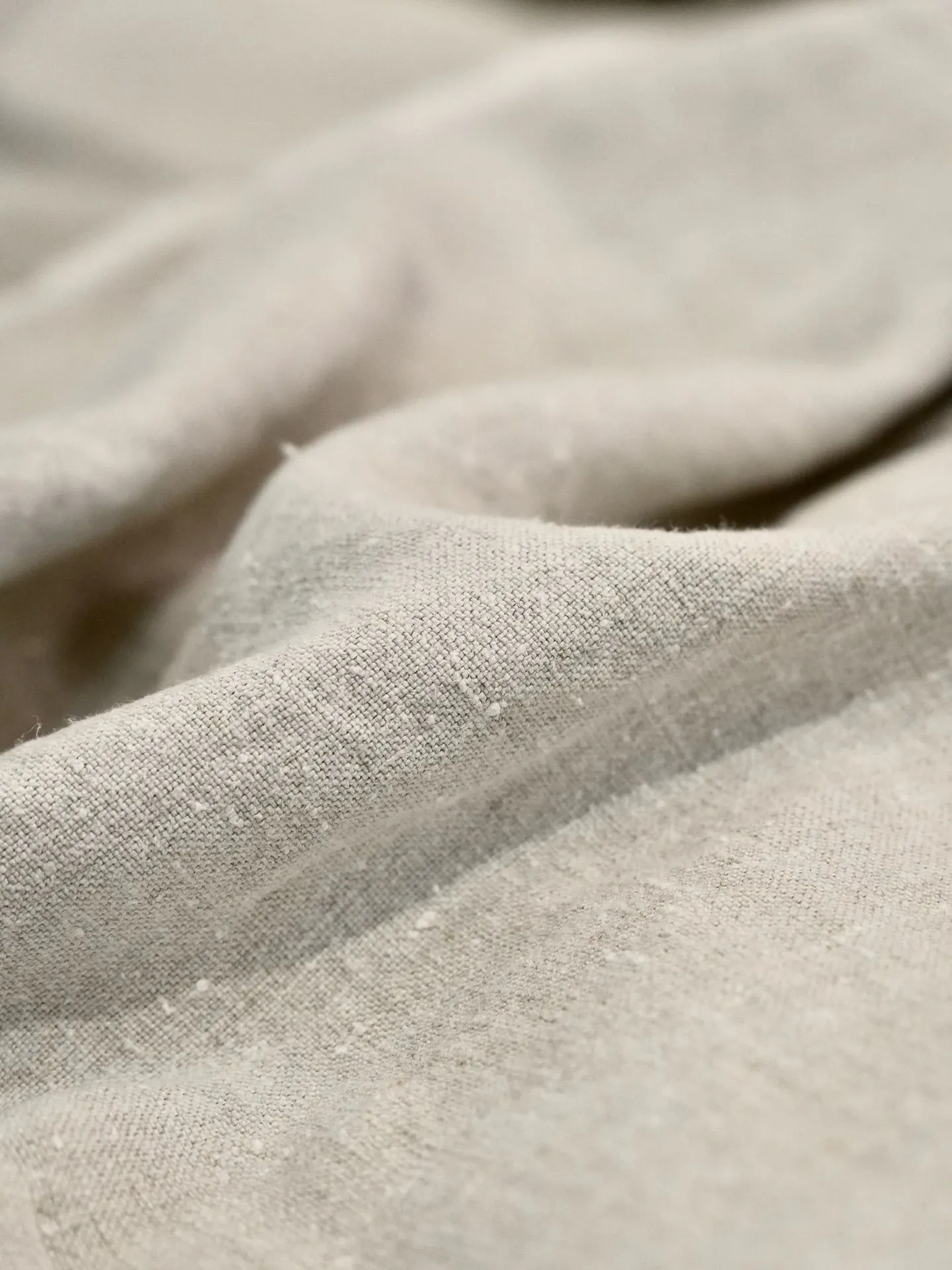 Close up of high quality navy blue linen fabric weave and button detail