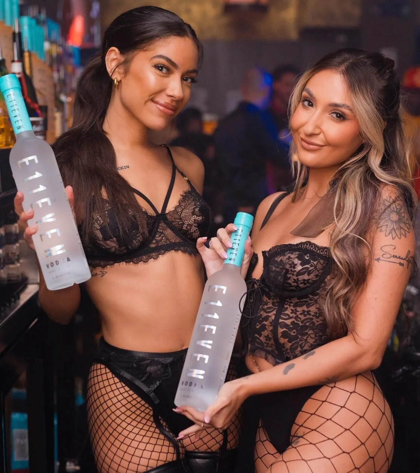 Women wearing edgy corsets and cut-out dresses in a Miami nightclub VIP section