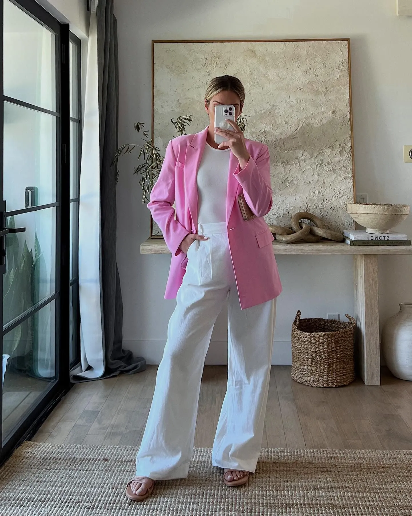 Woman wearing oversized pastel green blazer and white linen trousers for 80s theme cruise party