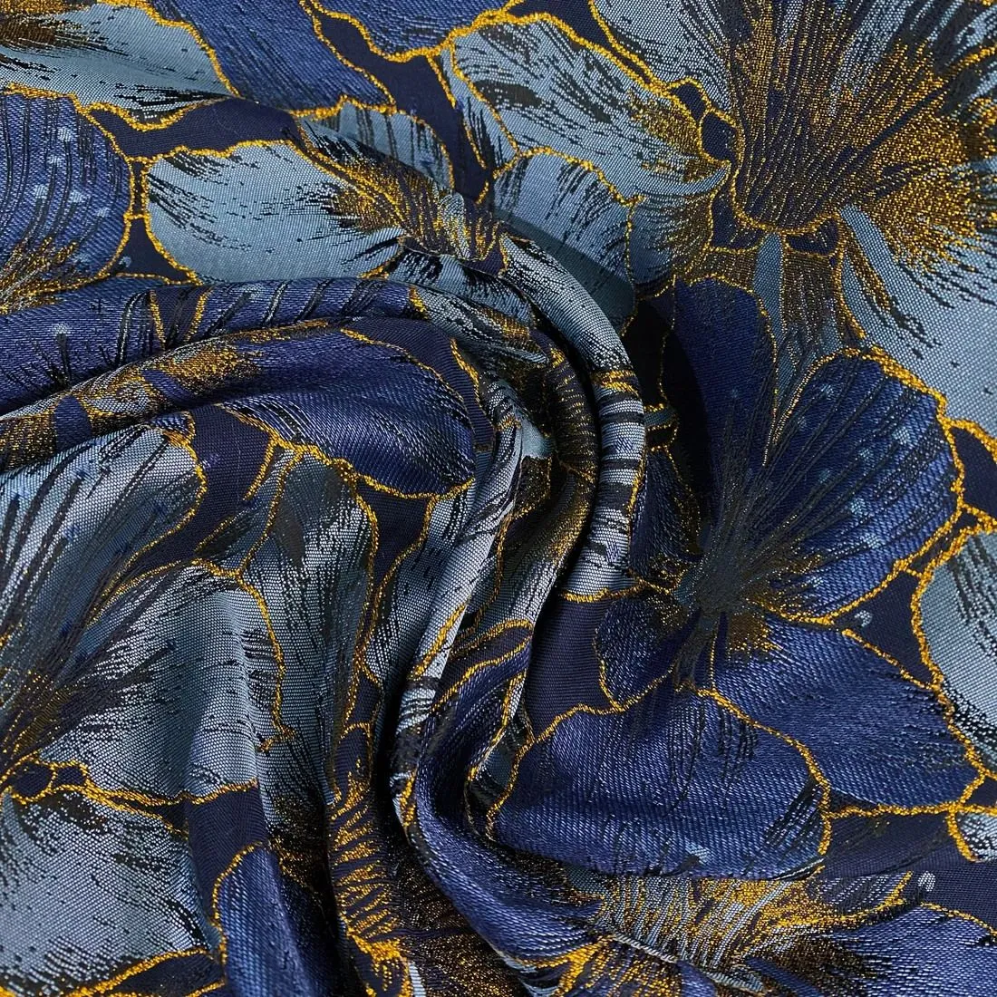 Close-up of a deep burgundy and black floral jacquard fabric with a woven texture