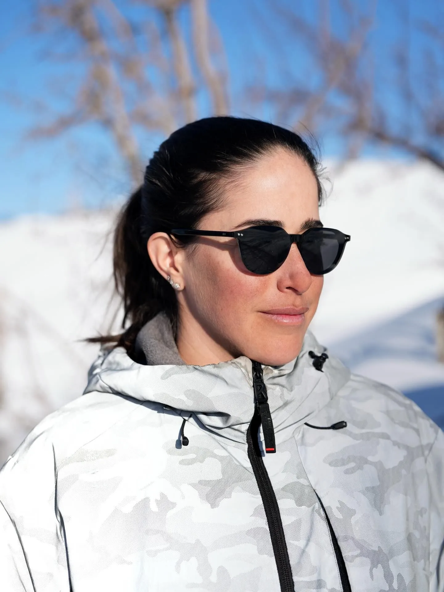 Woman wearing polarized sunglasses with snow reflection