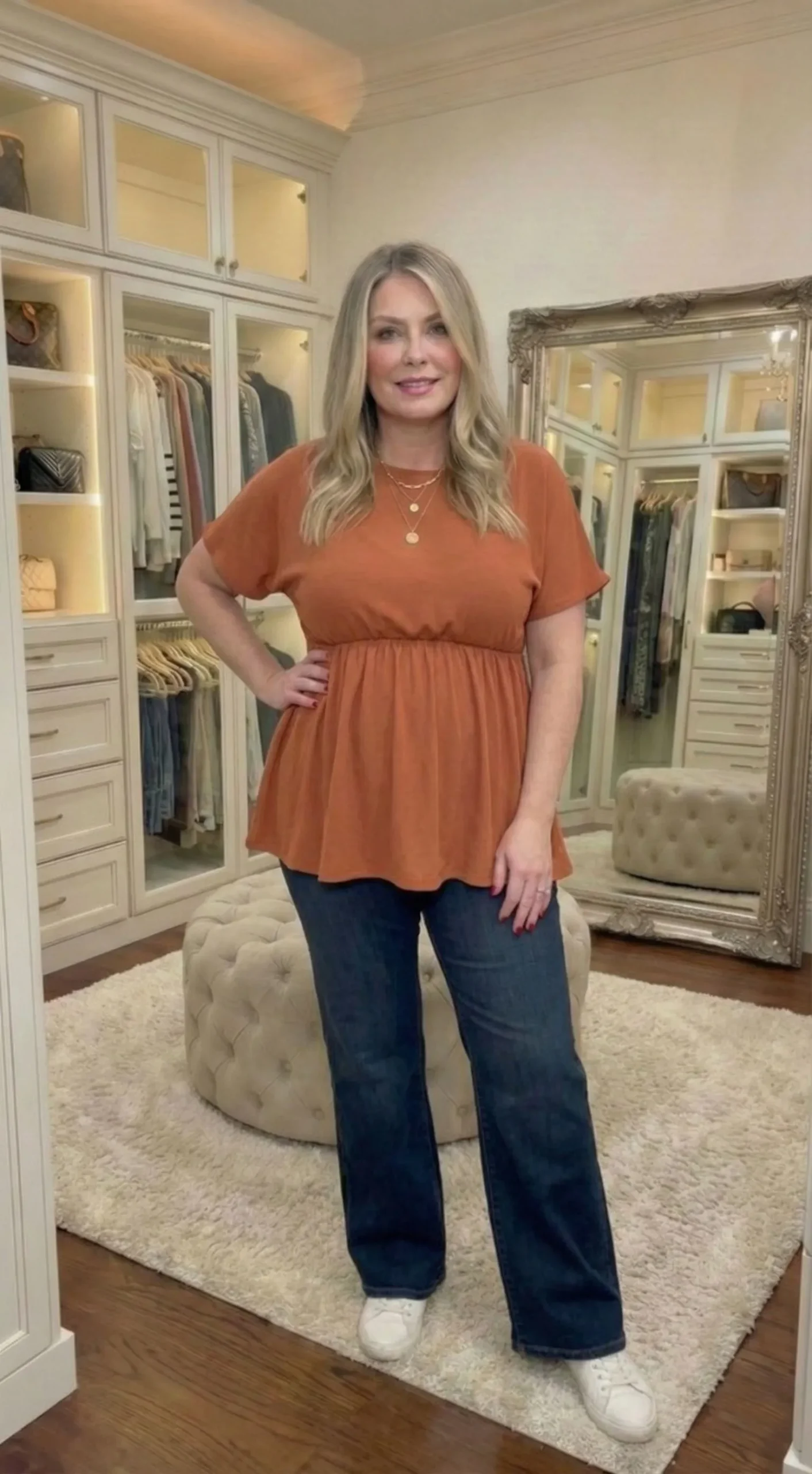 Plus size model wearing a flowy terracotta empire waist top for apple shape body