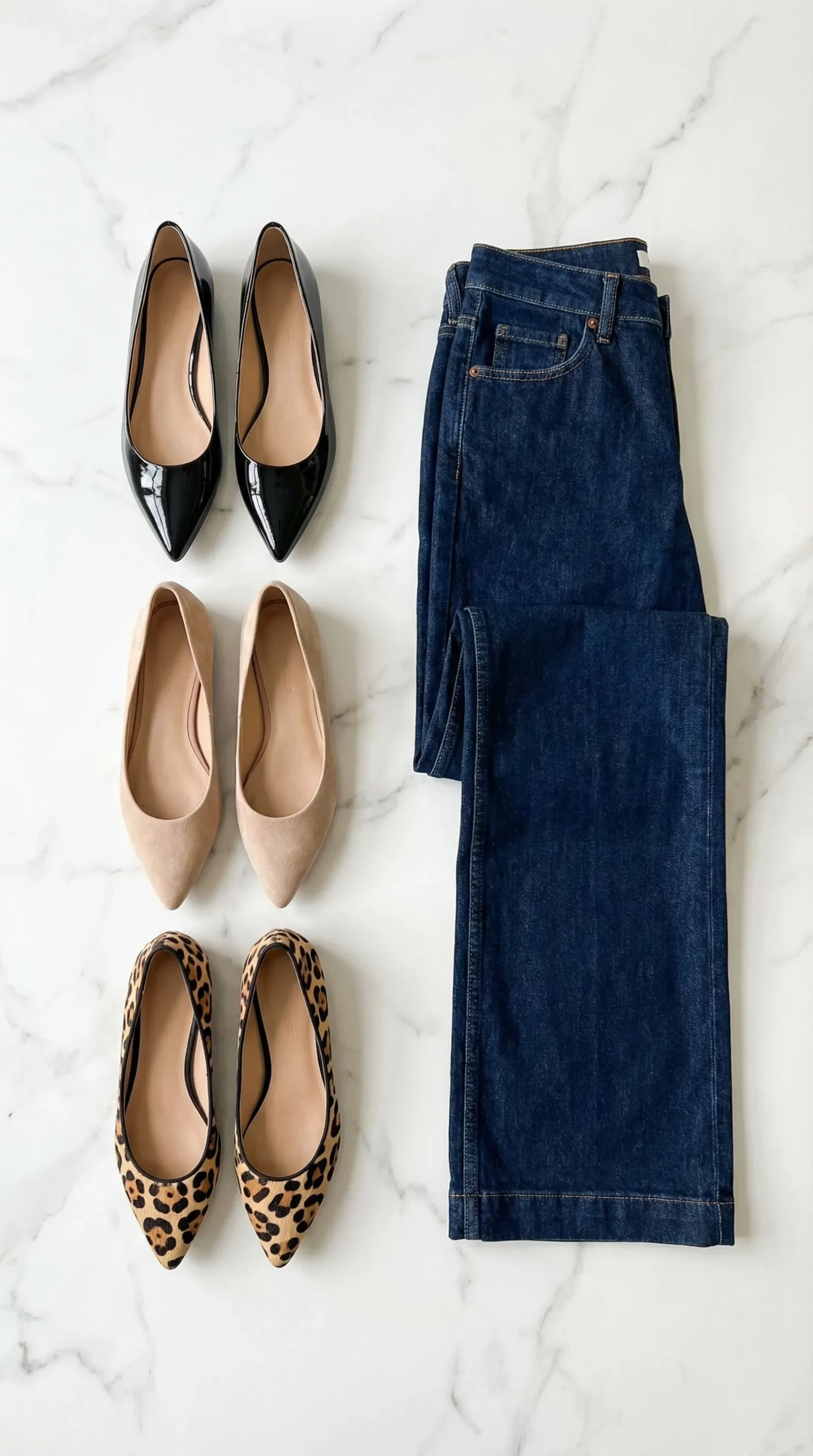 Selection of pointed-toe flats in black patent, nude suede, and leopard print next to denim