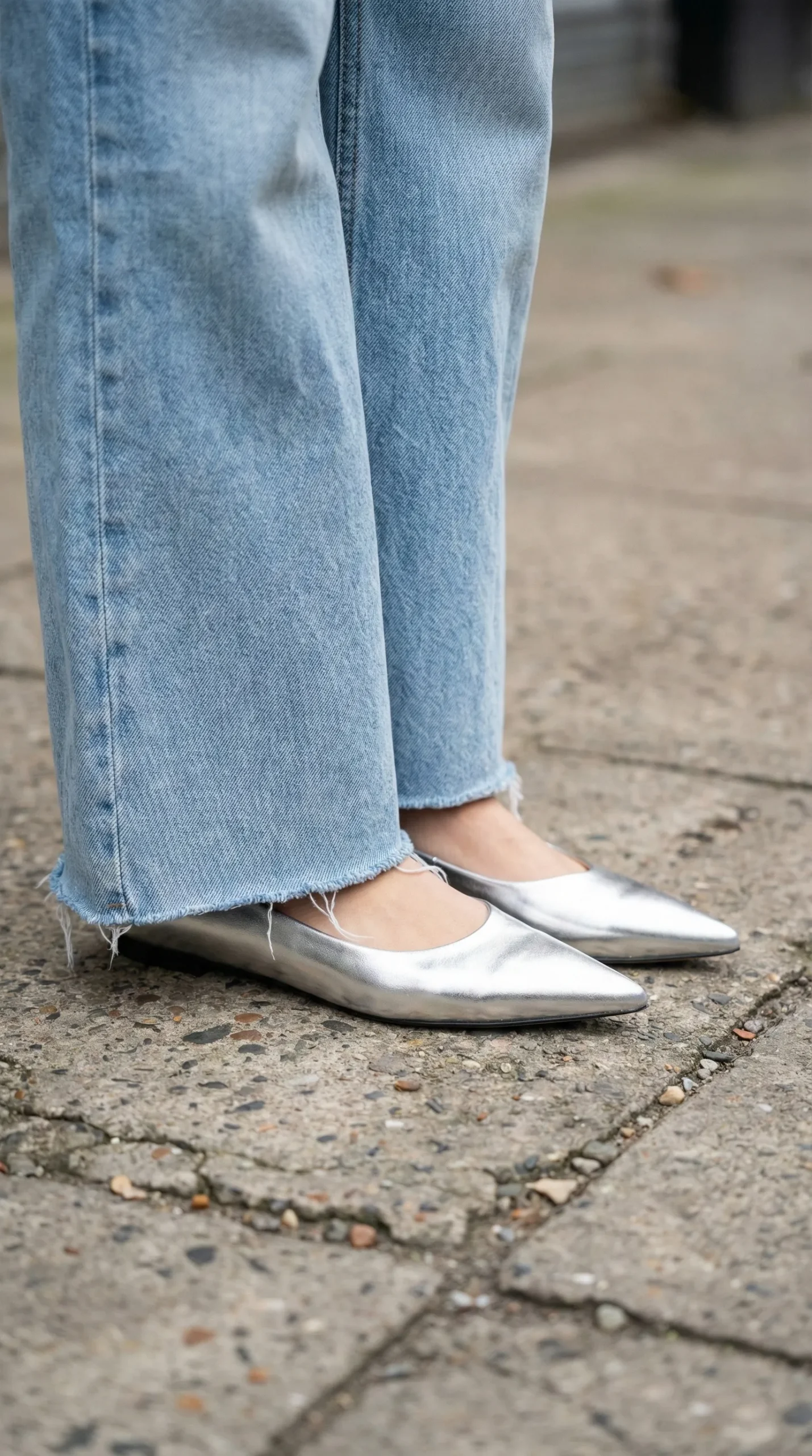 Petite woman wearing wide-leg jeans with metallic pointed-toe flats for a leg-lengthening effect