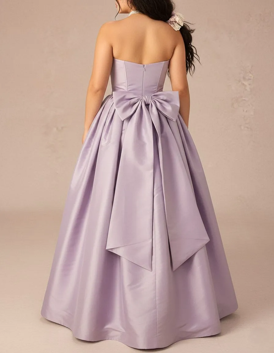Back view of woman wearing lavender empire waist dress with large satin bow