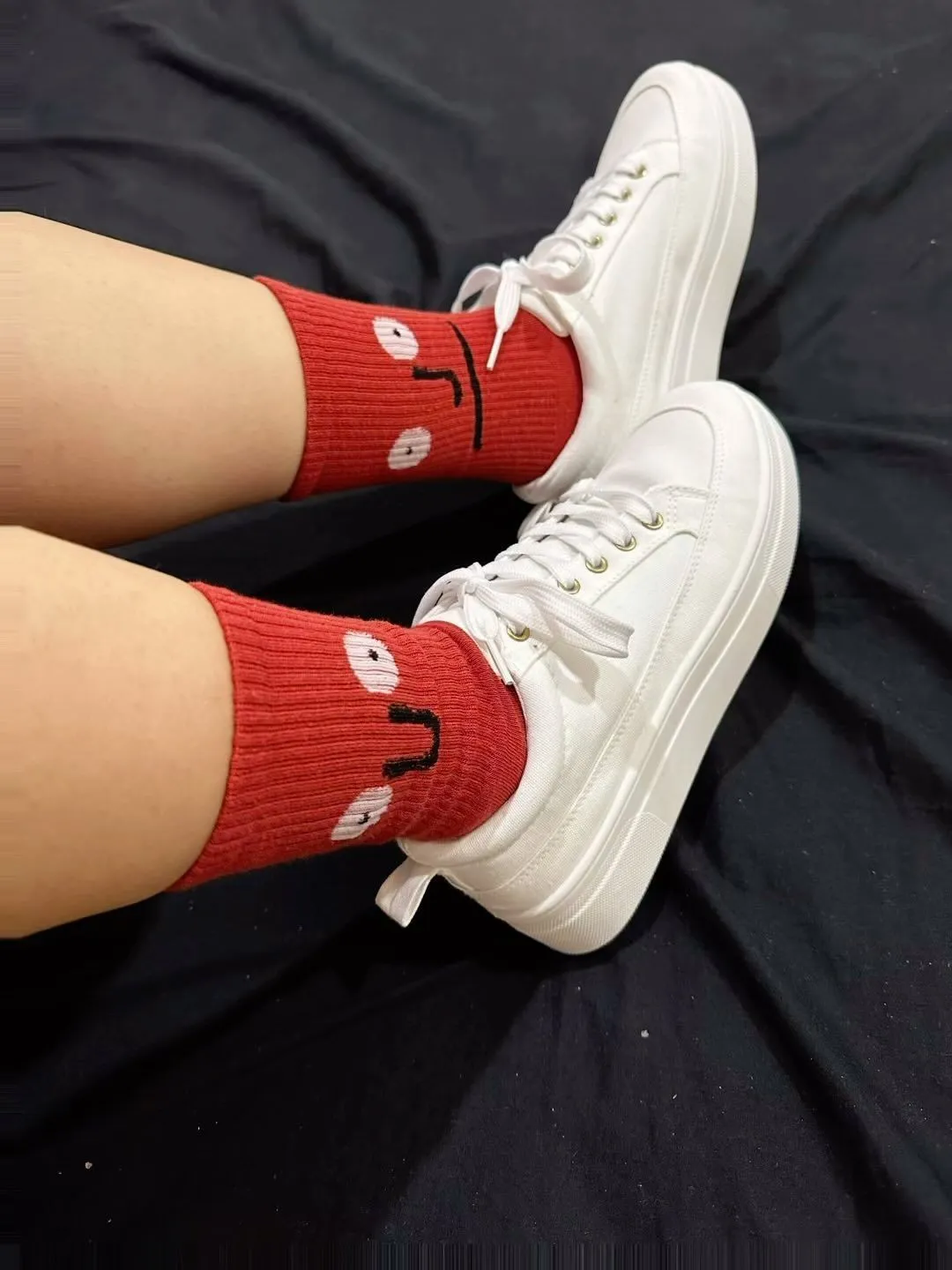 Chunky white sneakers and orange socks in a city pop style