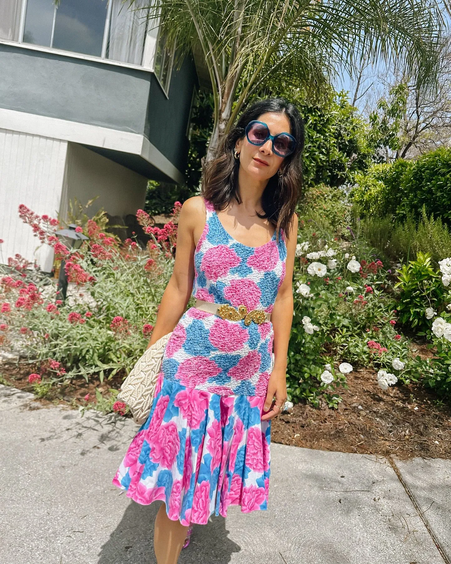 Woman in a colorful tropical print mini dress for city pop aesthetic.