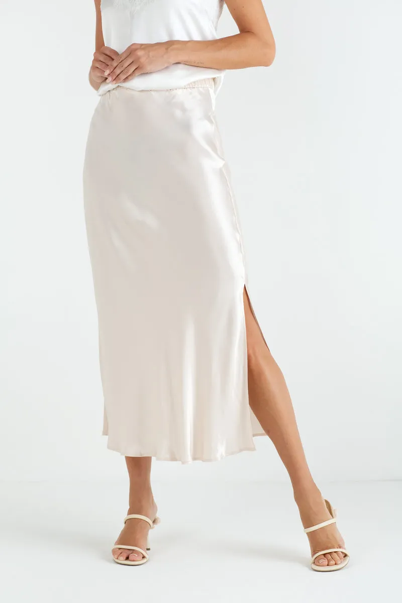 Hourglass figure styling with matte black bodysuit and champagne satin slip skirt