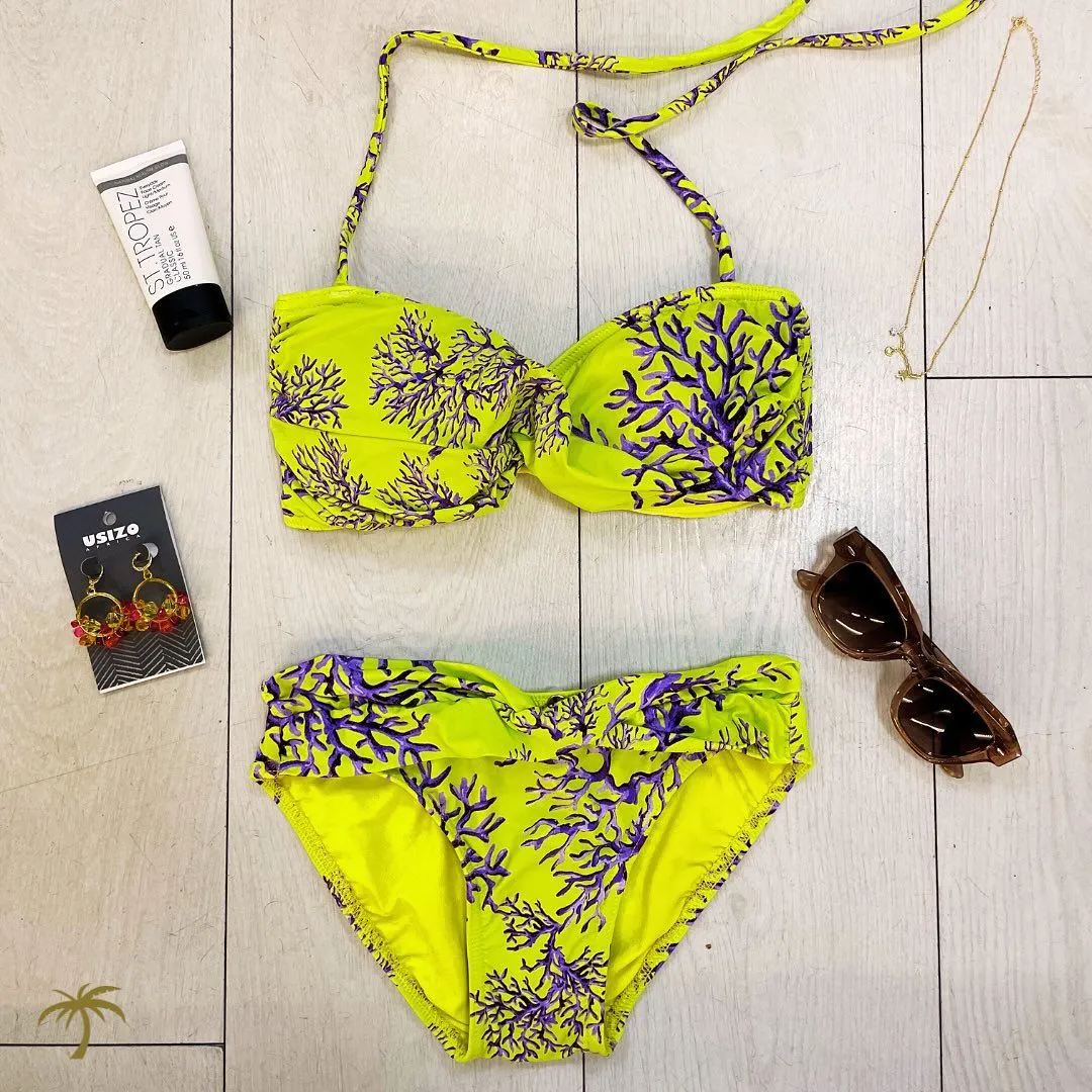 Floral rash guard with beauty accessories flat lay