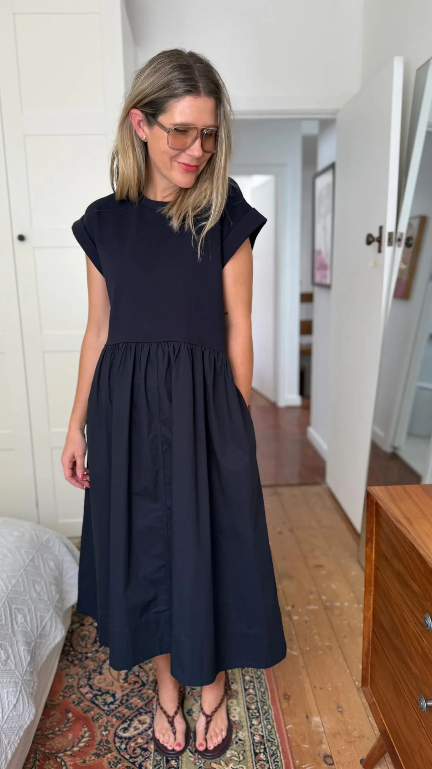 Model in a navy cotton poplin shirtdress for professional summer workwear