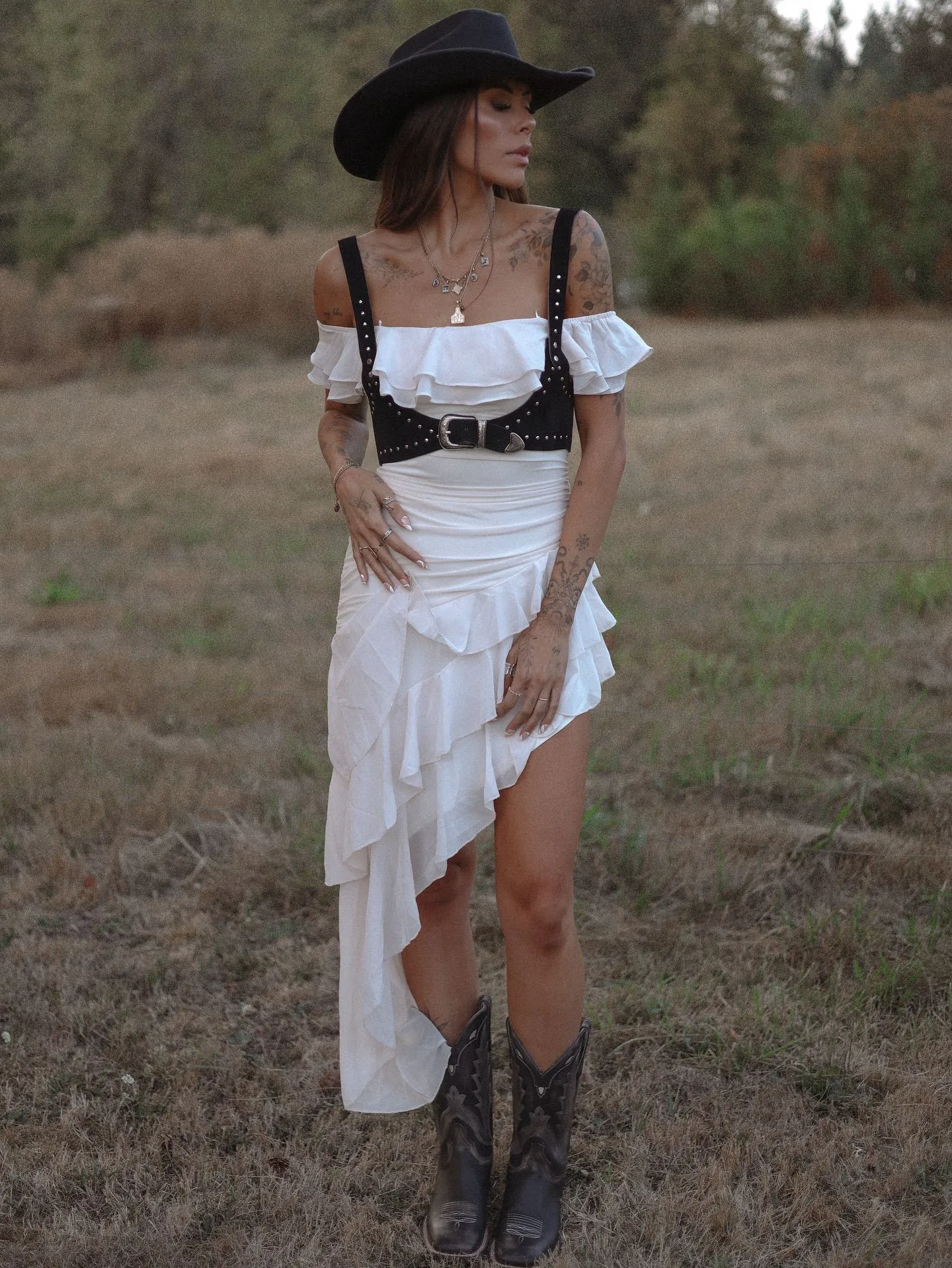 Model in terracotta western dress with concho belt and hat