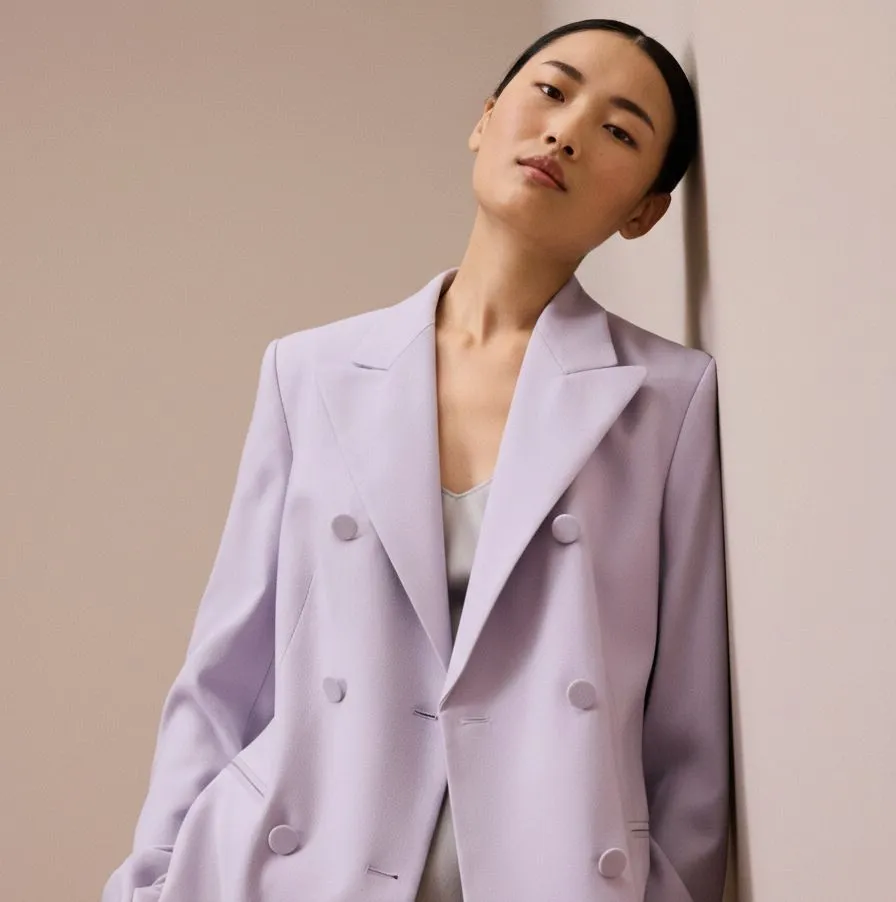 Close up of a tailored lavender blazer with silk camisole