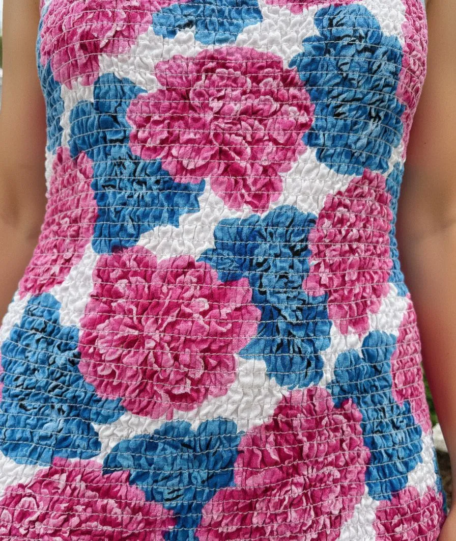 Close up of a vibrant tropical print fabric with neon colors.