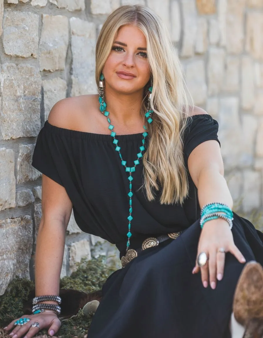 Turquoise squash blossom necklace on white western dress