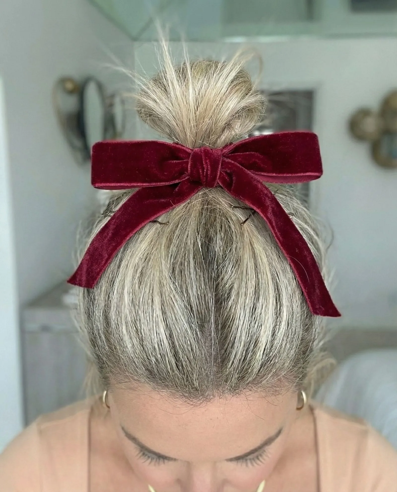 Close up detail of velvet bow accessory on a brunette top knot
