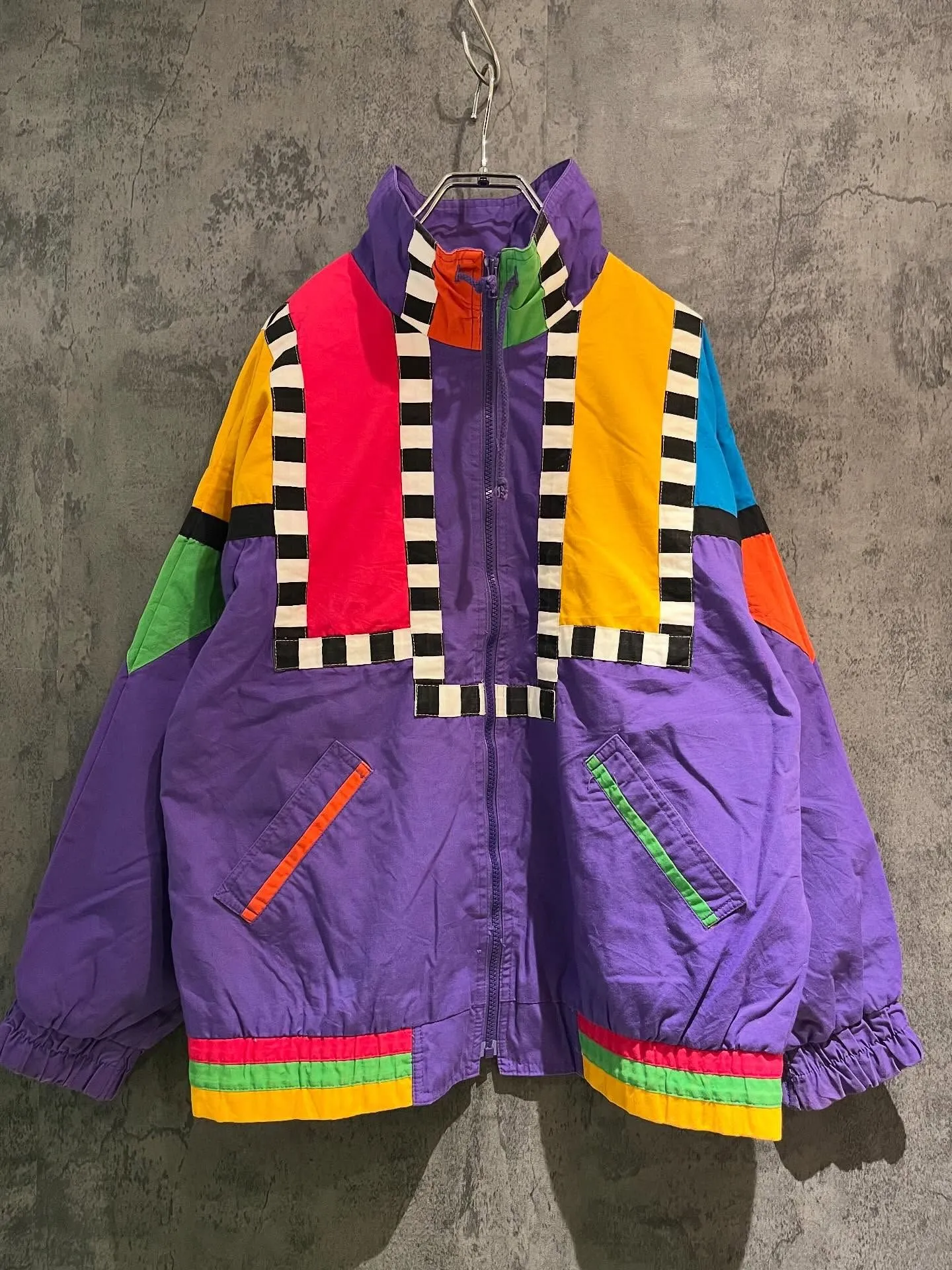 Close up texture of yellow and blue nylon windbreaker jacket for 80s costume