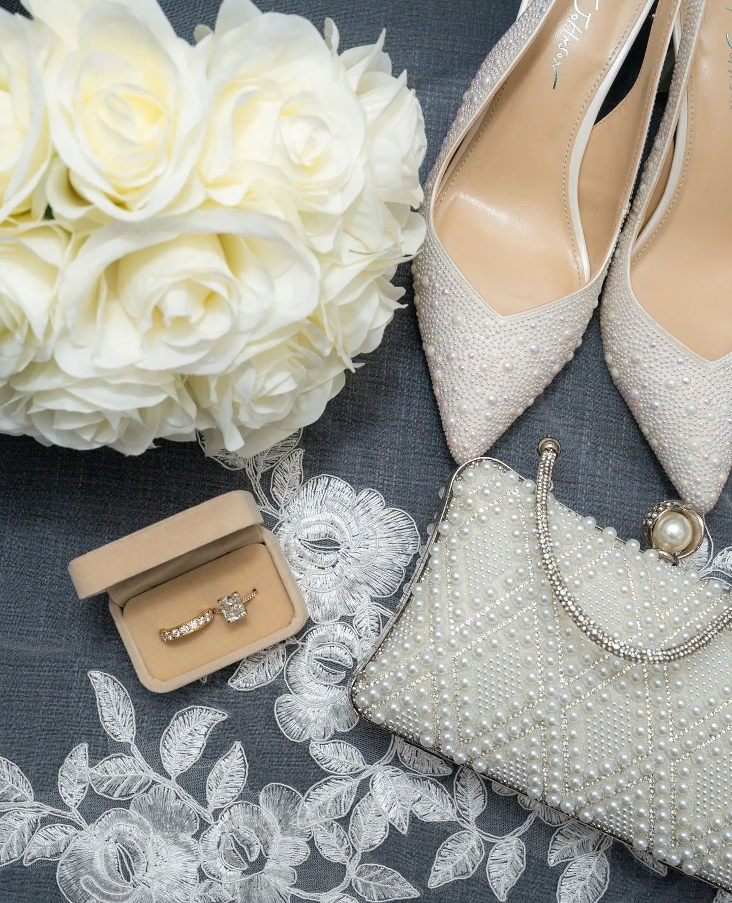 Silver jewelry and pearl accessories styled with powder blue fabric