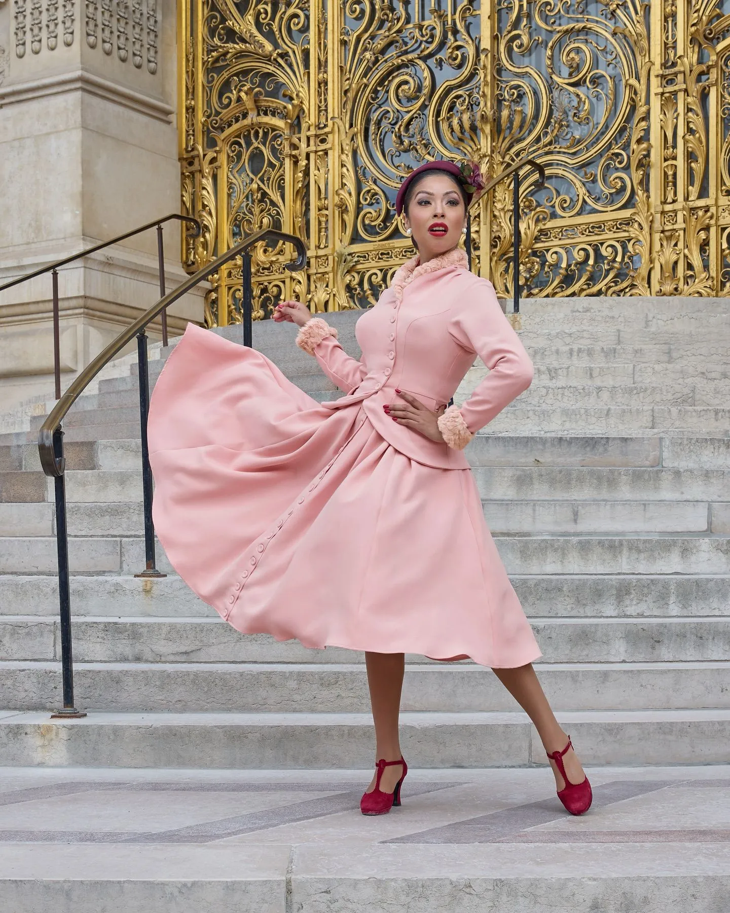 Black woman wearing a tailored blush pink A-line skirt suit for Easter church service