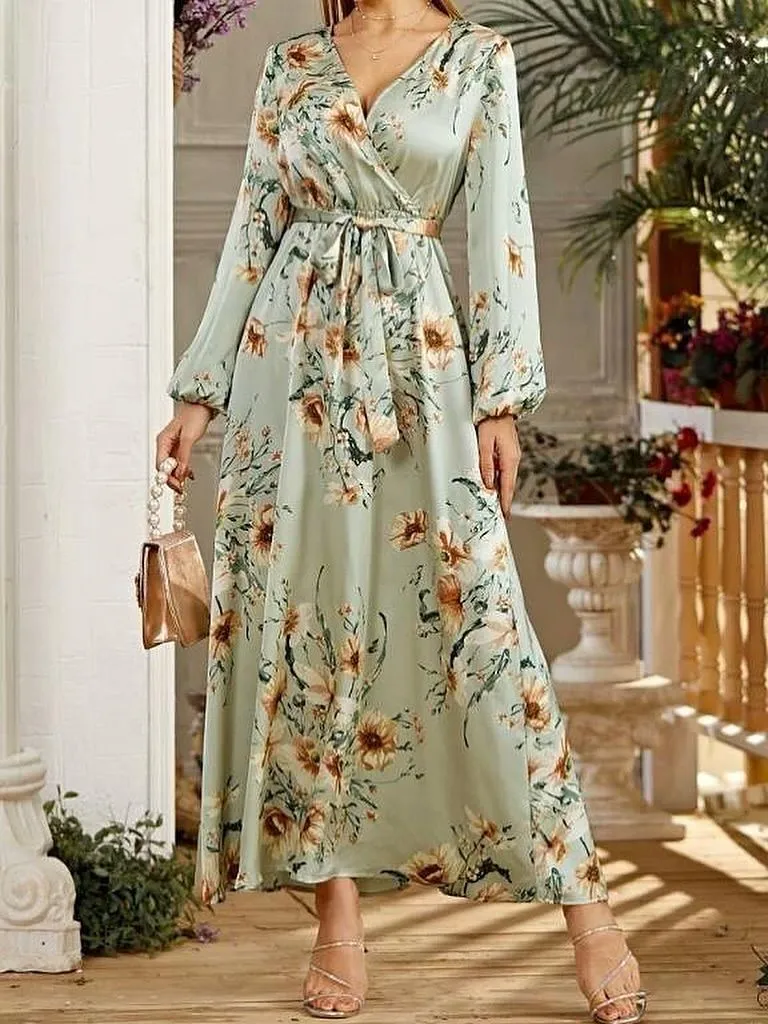 Woman over 50 wearing a lilac floral wrap dress with adjustable waist tie in a garden setting