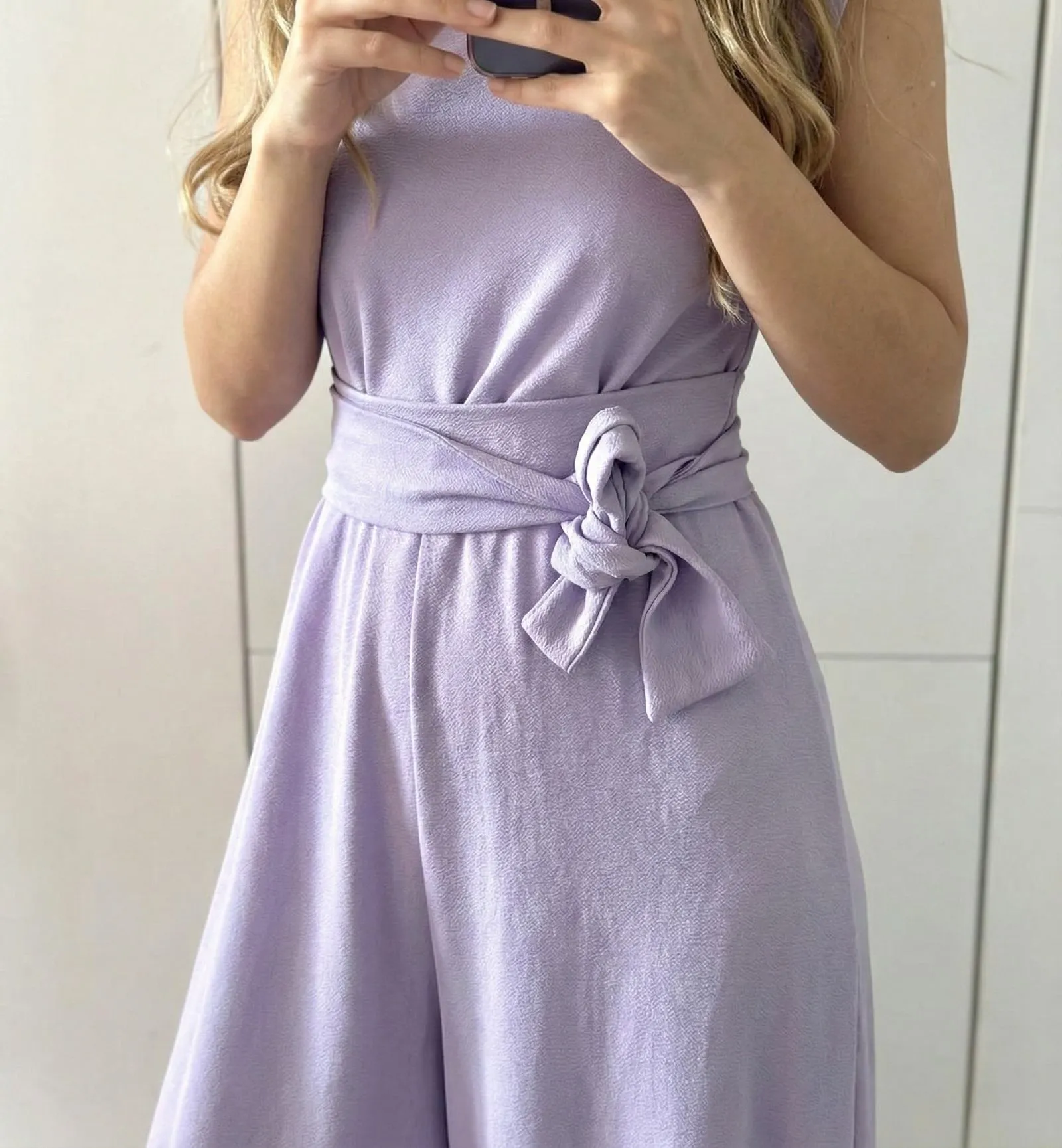 Close up of belted lavender crepe jumpsuit fabric texture