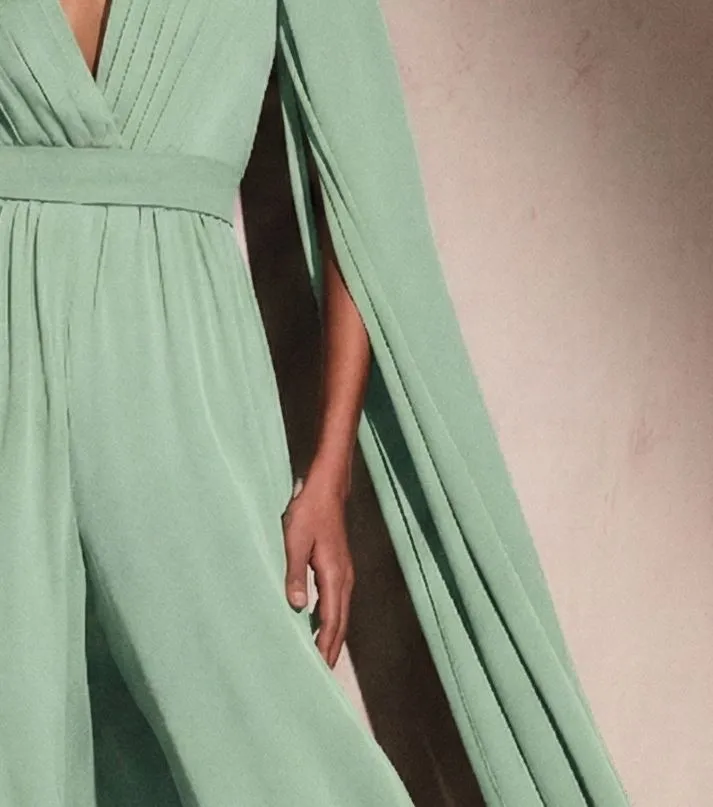 Close up texture of lilac crepe and chiffon fabric on a cape sleeve jumpsuit