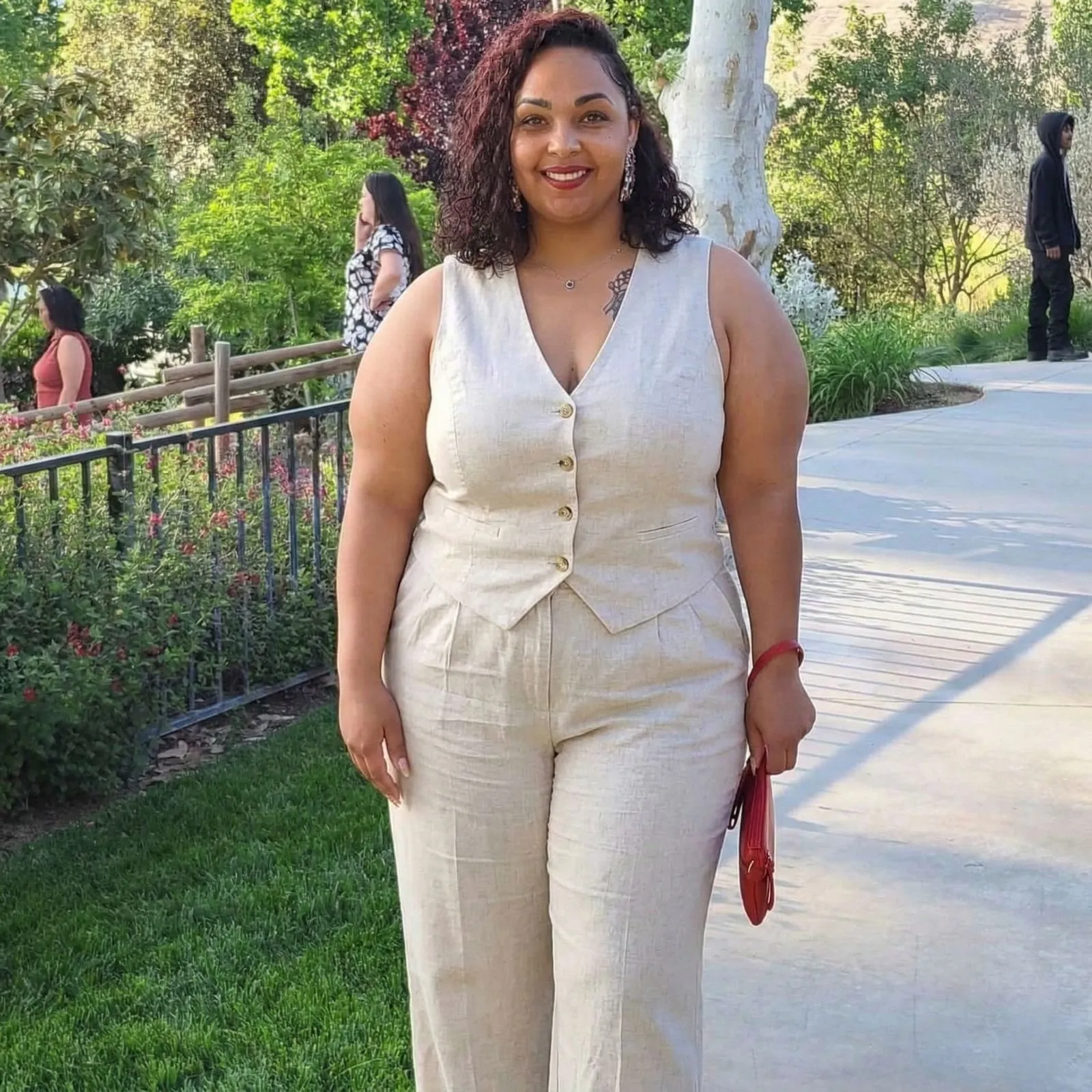 Plus size woman wearing oatmeal linen tailored vest and trousers for business casual summer outfit