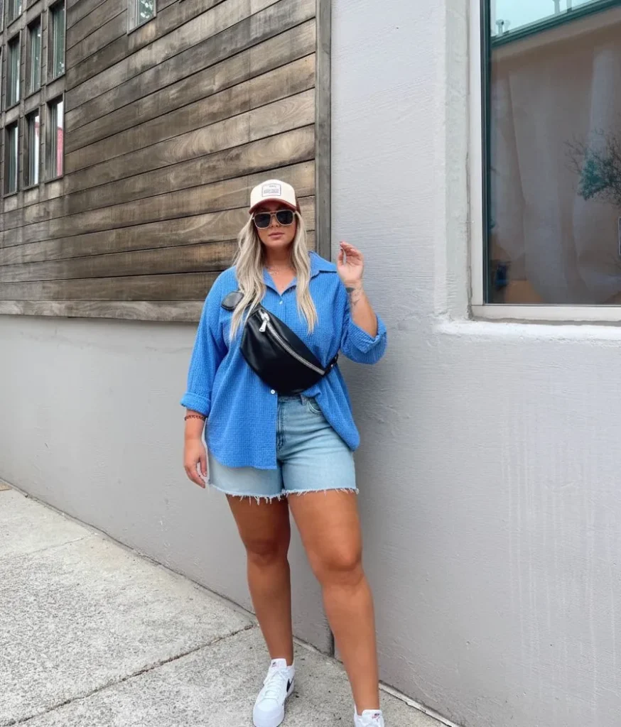 Plus size woman wearing a blue seersucker shirt at a baseball game