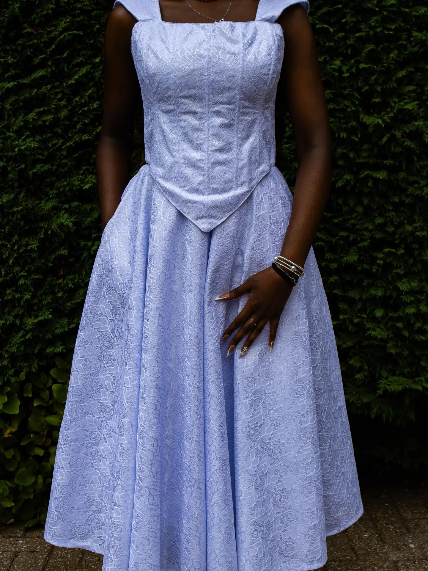 Black woman wearing elegant powder blue jacquard skirt suit for Easter church service