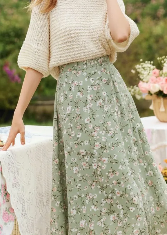 Close up detail of fitted knit top tucked into floral maxi skirt