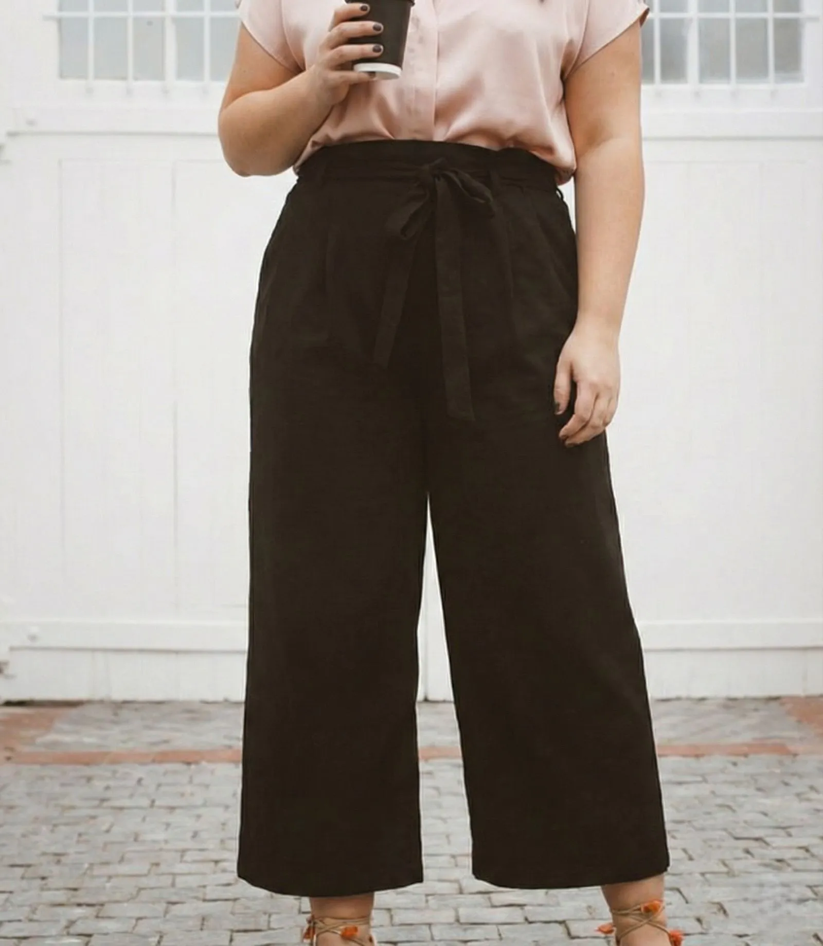 Detail shot of high waisted cotton poplin culottes with tucked in silk blouse on curvy body