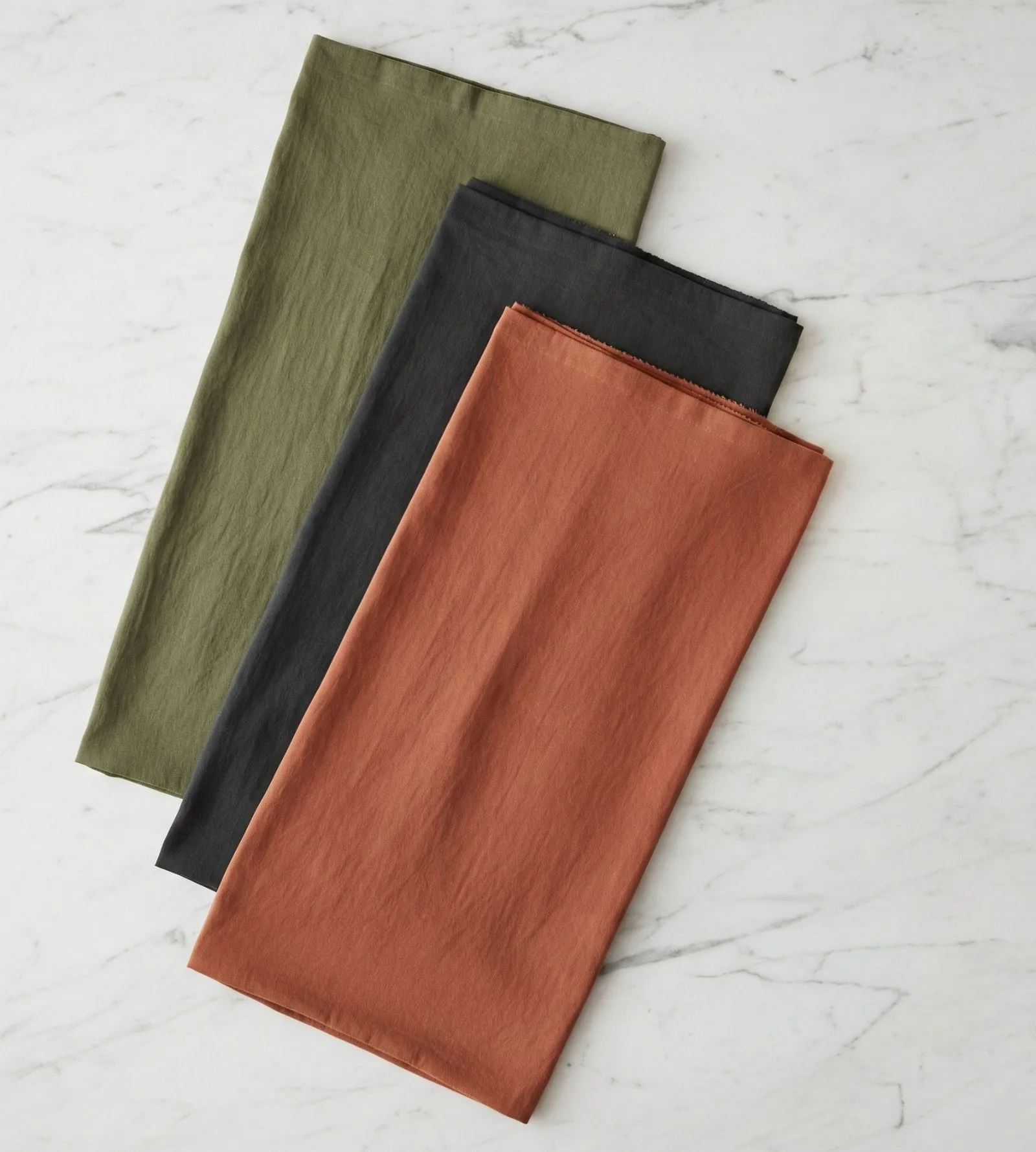 Flat lay of breathable cotton poplin fabric swatches in professional summer colors