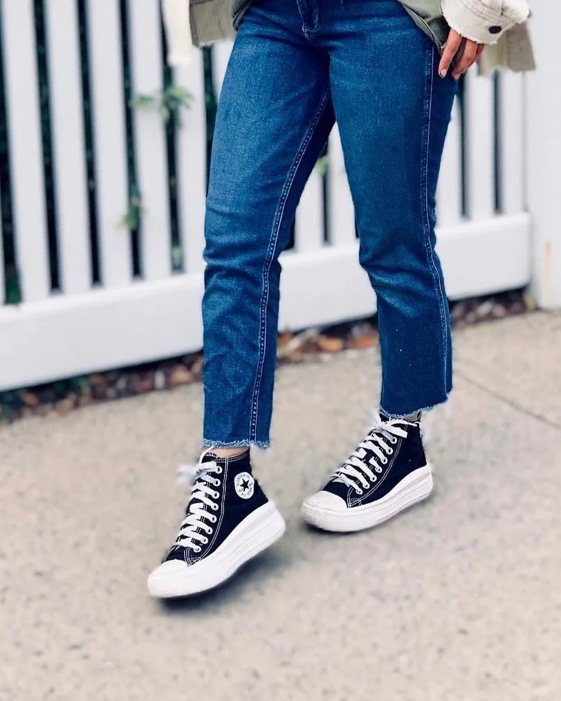 Woman modeling black high-top sneakers with cropped straight jeans for fall