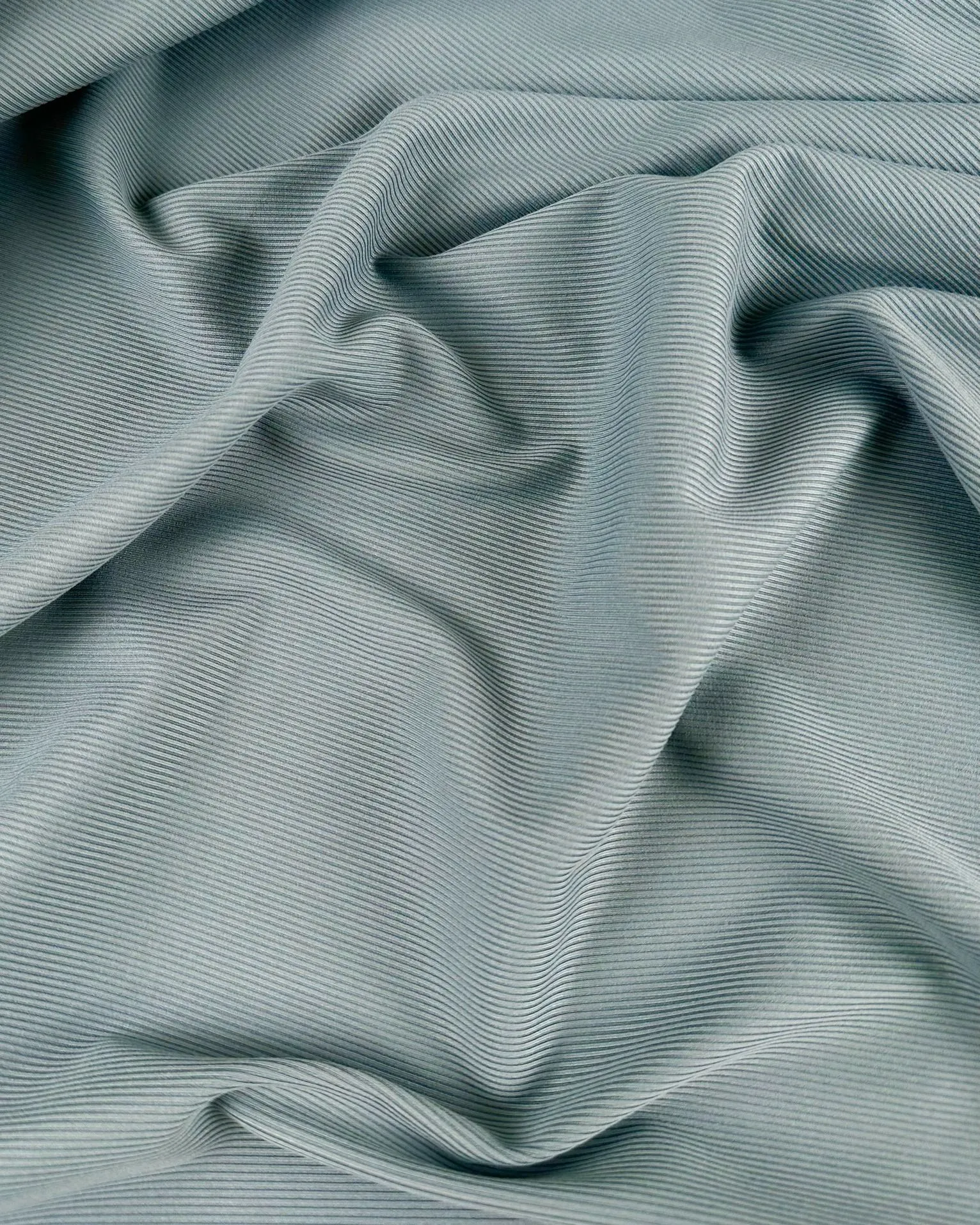 Close up of piqué knit fabric in pistachio green