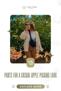 A stylish woman wearing mustard wide-leg corduroy pants and a chunky knit sweater in a sun-drenched apple orchard.