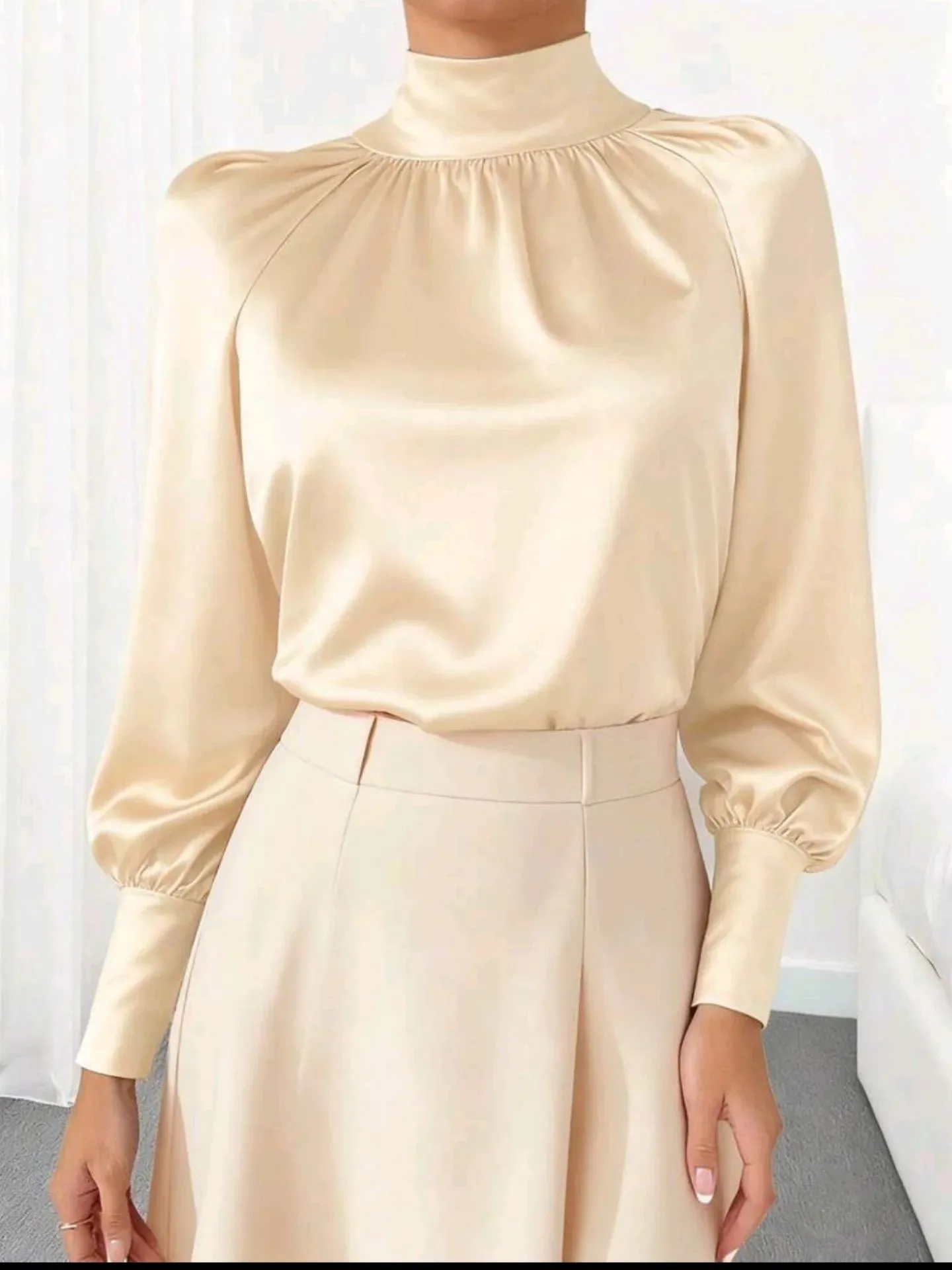 Clean girl aesthetic outfit featuring a champagne silk blouse and ivory culottes for work.