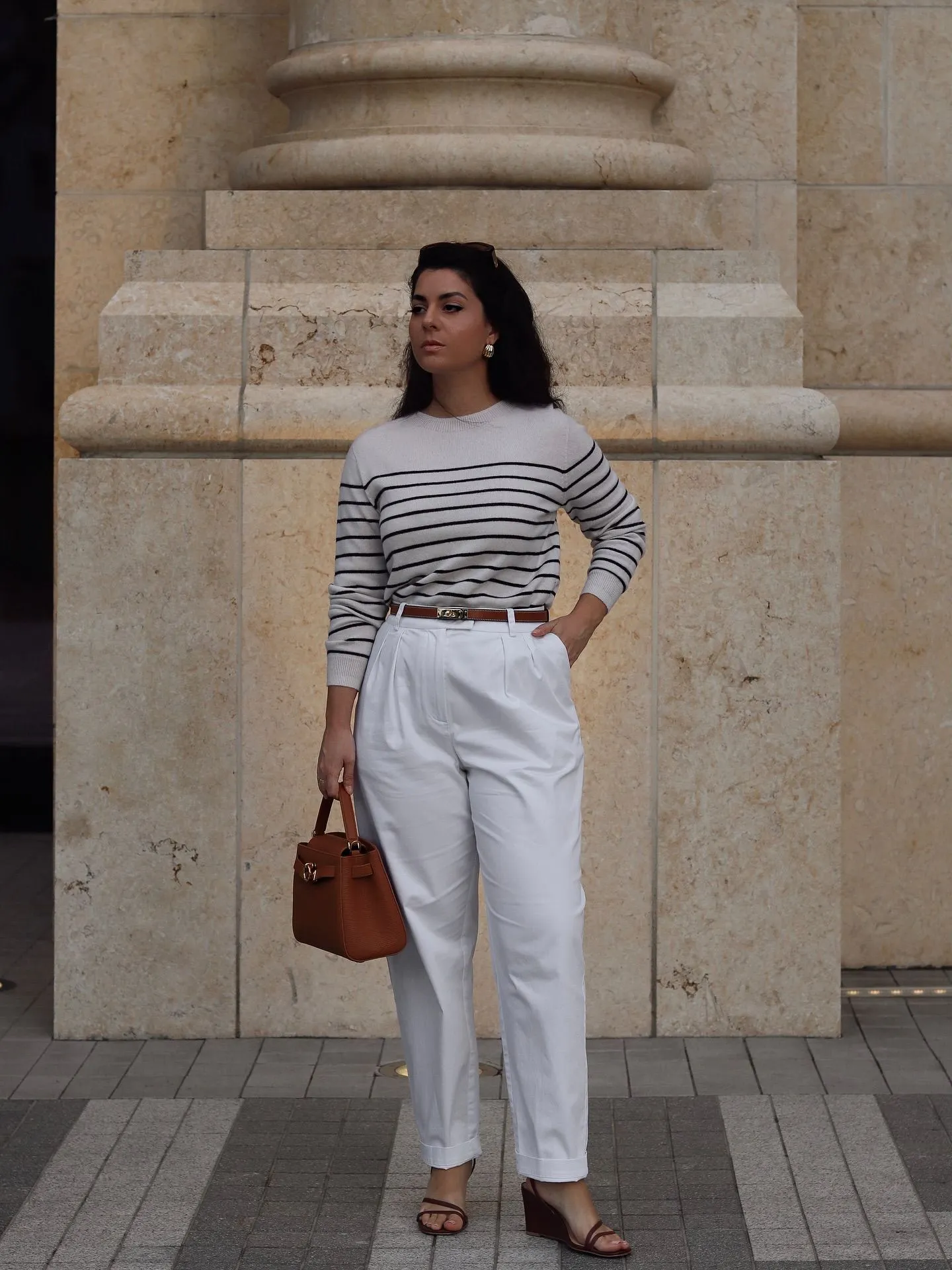 Chic woman in white trousers and Breton stripe tee