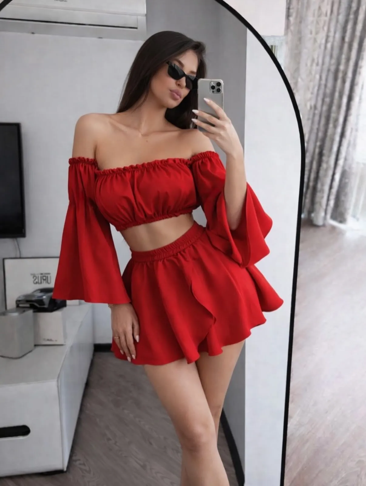 Petite woman styling a red matching skort set with chunky platform sneakers