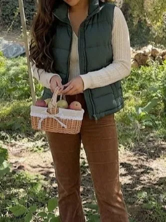 Close up of mustard puffer vest and rust corduroy fabric textures