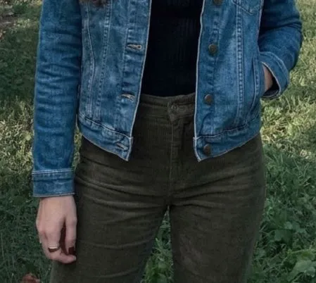 Close up of a ribbed turtleneck and denim jacket silhouette