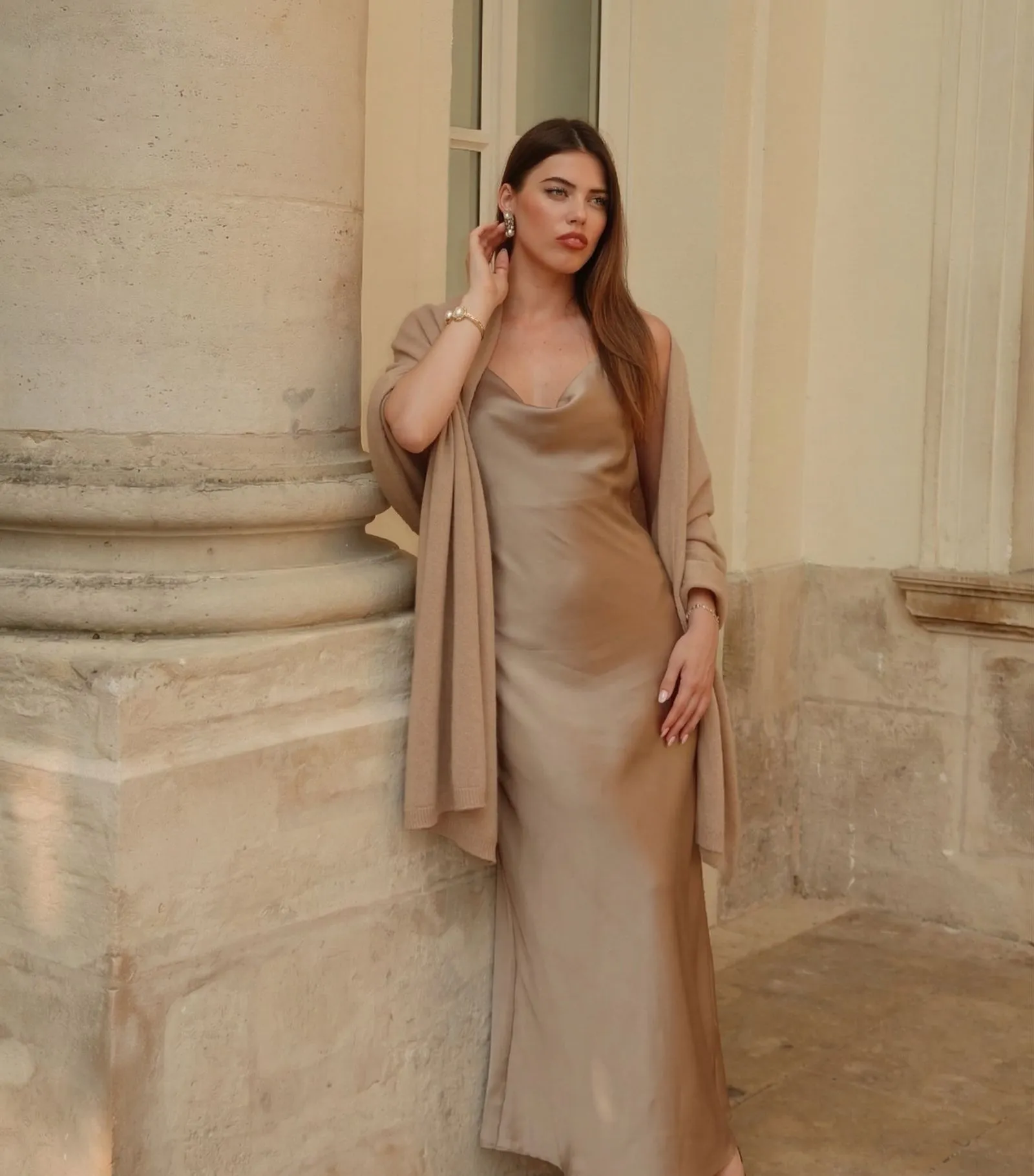Woman wearing monochromatic sand silk slip dress and cashmere wrap