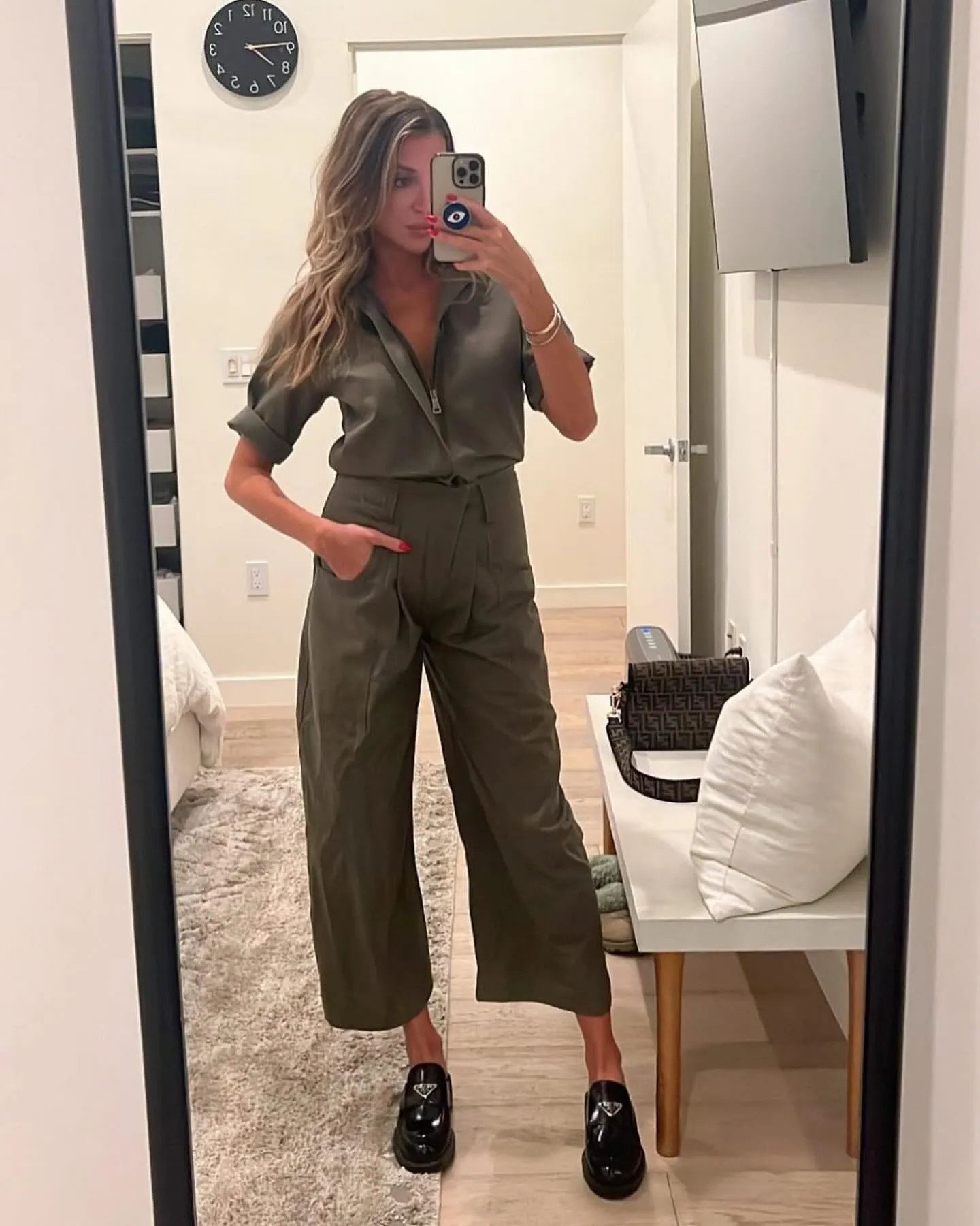 Petite woman wearing a comfortable olive green utility romper for a summer music festival
