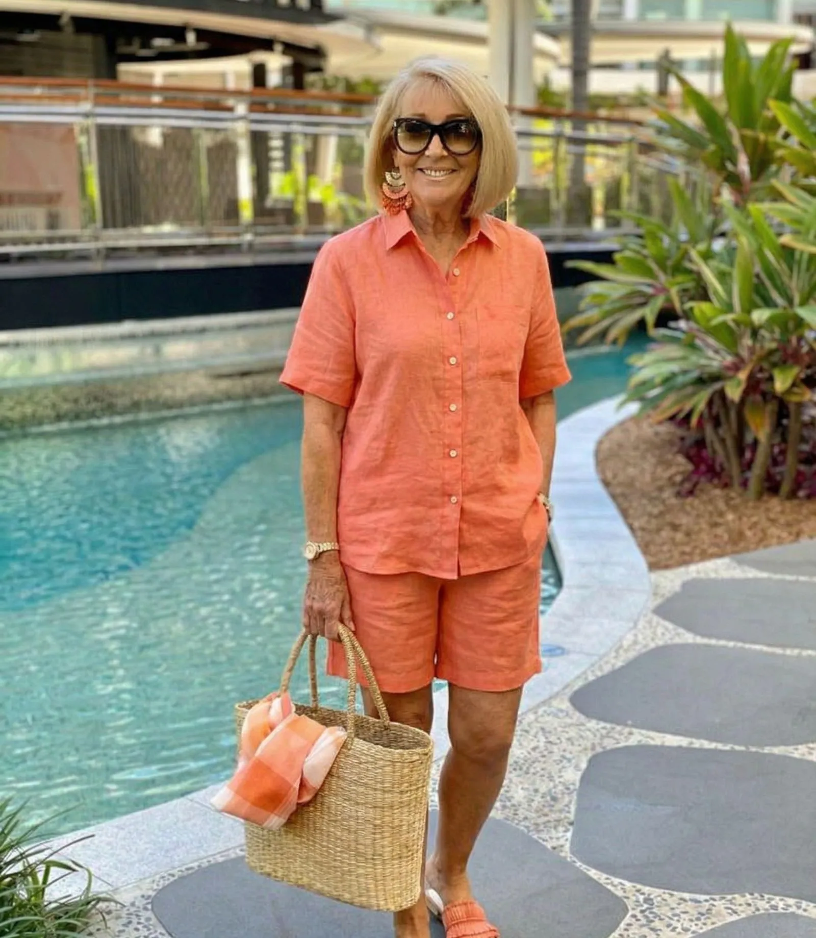 Woman over 40 wearing breathable orange linen set for warm weather football game