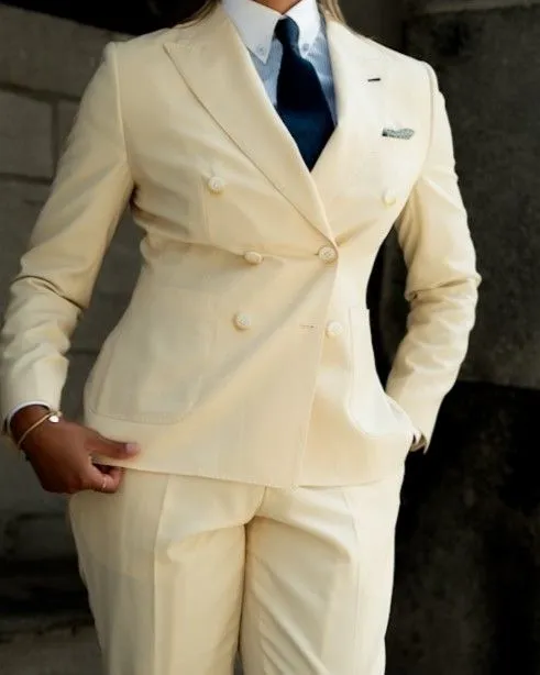 Close up of a tailored cream blazer and trouser set showing high-quality stitching.