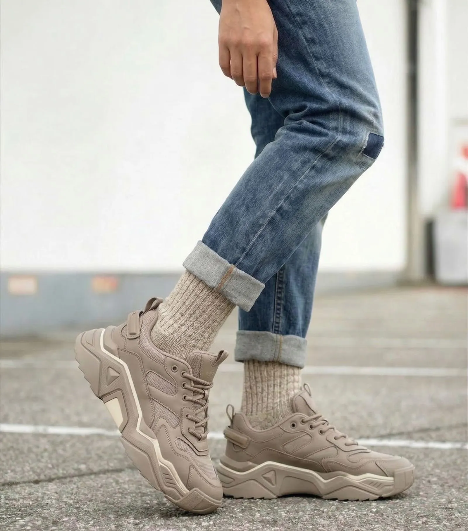 Close up of taupe dad sneakers with ribbed socks